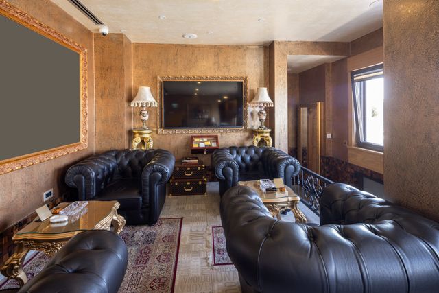 Boutique-hotel lounge with leather Chesterfield seating and warm metallic wall finishes