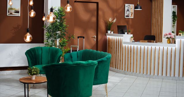 Boutique-hotel reception with a fluted counter, green velvet chairs and glass pendant lights