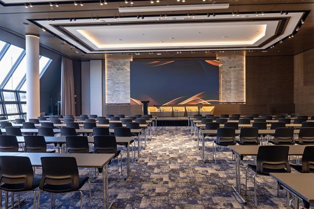 Conference and training hall with integrated stage lighting and flexible seating