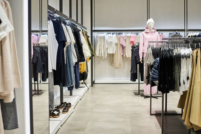 Modern clothing showroom with display rails and a spacious shopping aisle